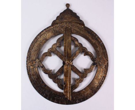 AN ISLAMIC CHASED COMPASS, with chased calligraphy and symbols and a revolving hand, 36cm widest point.