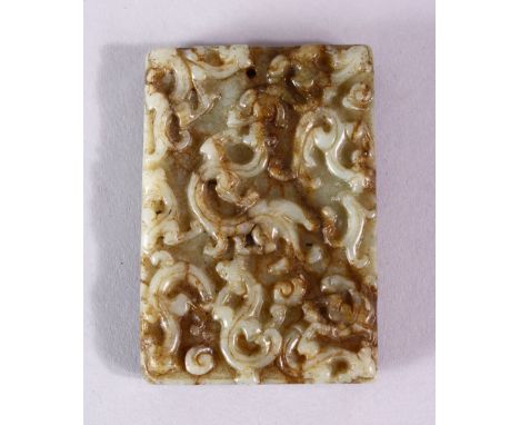 A 19TH CENTURY SPECKLED JADE RECTANGLAR TABLET, carved with scrolls, 6.5cm x 4.5cm.