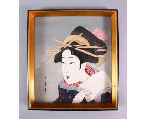 A JAPANESE WOODBLOCK PRINT OF A KABUKI ACTOR - KITAGAWA UTAMARO - depicting a posed kabuki actor in traditional gowns holding