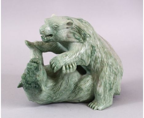 A CHINESE CARVED GREEN HARD STONE MODEL OF TWO PLAYING BEARS, 14cm high x 18cm wide.