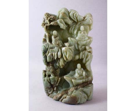 A LARGE AND HEAVY CHINESE CARVED JADE BOULDER - BUDDHA - the large heavy boulder carved in fine detail to depict three vcaryi