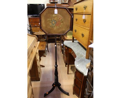 A Victorian fire screen pole on splayed legs with a tapestry screen.