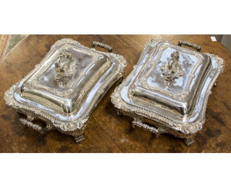 A pair of George III silver entree dishes in Old Sheffield Plate twin handled stands, with shell and foliate gadrooning to th