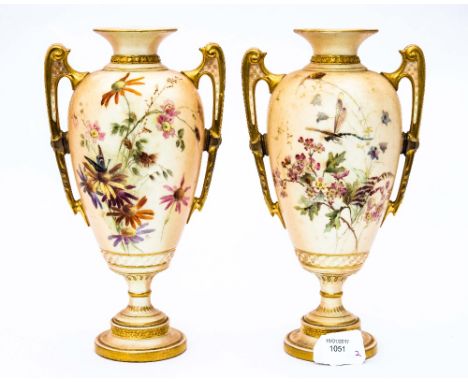 A pair of Royal Worcester blush ivory twin handled vases, pedestal form, Grecian handles, decorated with wild flowers and dra