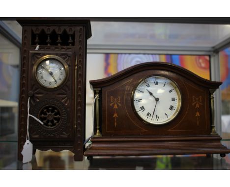 An arched top wooden mantle clock with inlay to sides, French brass movement