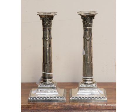 A pair of Victorian silver Corinthian column candlesticks, square bases 24 cm high, maker William Gibson & John Langman Londo