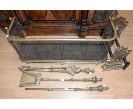 A brass and iron fire surround, a pair of brass lion fire dogs and a Victorian fire side companion set (6 items) 