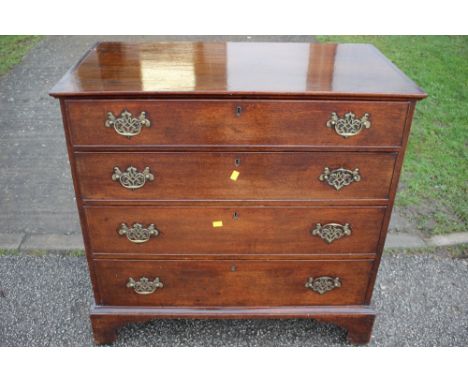 A George III mahogany chest of drawers, fitted with four long graduated drawers, raised on bracket feet 