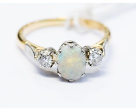 An opal and diamond three stone 18ct yellow gold ring, the centre opal cabachon approx 8 x 6mm, total diamond weight approx 0