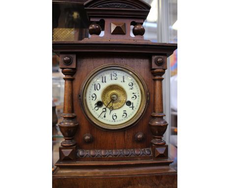 An Edwardian veneered mantel clock, circular enamel dial with Arabic numerals and twin winding holes