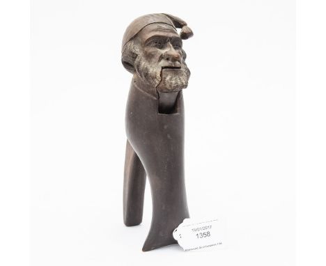 A Bavarian wooden novelty Nutcracker, with carved portrait of gentlemen in cap 