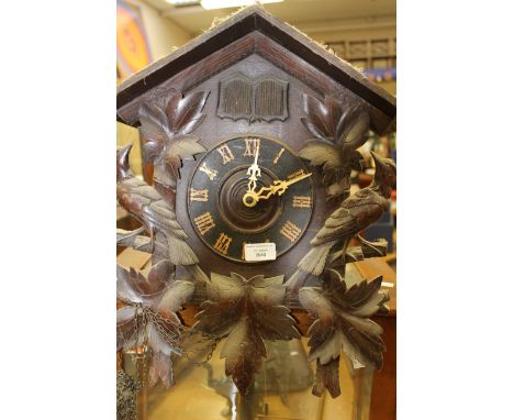  A 20th Century black forest wall hanging cuckoo clock, complete with three weights