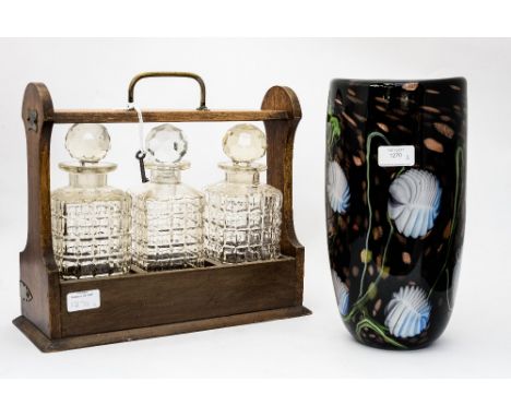 A Studio glass vase, black ground with water lillies, with a tantalus, including key and pressed glass decanters (2) 