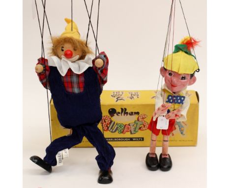 A boxed Pelham puppet - clown yellow box; together with a Marionette of Pinocchio (2) 