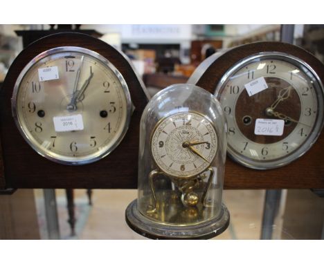A Smiths Enfield dome topped mantle clock, with another domed top mantle clock, a German Koma Skeleton type clock under glass