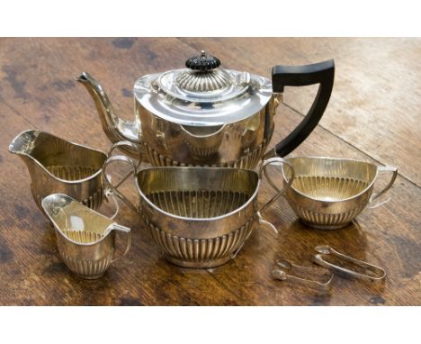 A silver tea service comprising teapot, sugar bowl and milk jug by Emile Viner, hallmark Sheffield 1931, 1933 and 1936, a fur