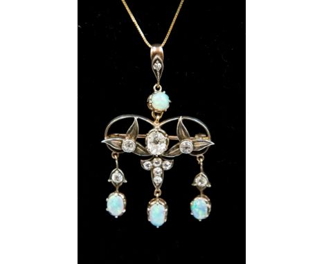 An Edwardian diamond and opal triple drop pendant/brooch comprising four black opals of blue green play of colour and ten old