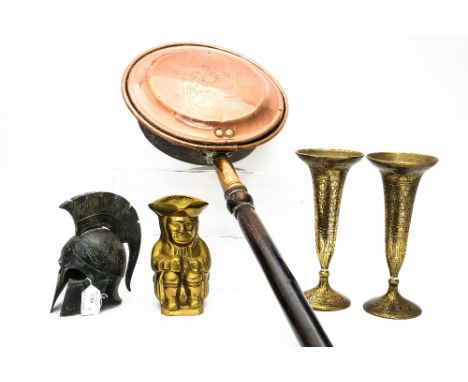 A pair of Indian Bidri trumpet vases, a copper warming pan, a brass Toby jug and a metal helmet (scaled down) 