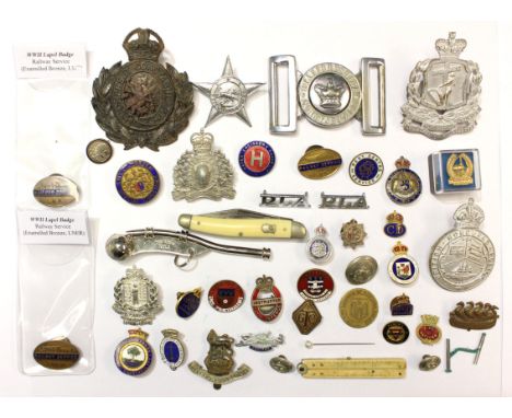 A collection of enamel lapel badges, foreign Police cap badges, WW2 Railway service badges LNER LMS GWR, pen knife, Bosuns wh