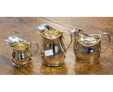 A George III silver helmet shape cream jug, Peter & William Bateman, London 1809, 3.61ozt; together with two Edwardian silver