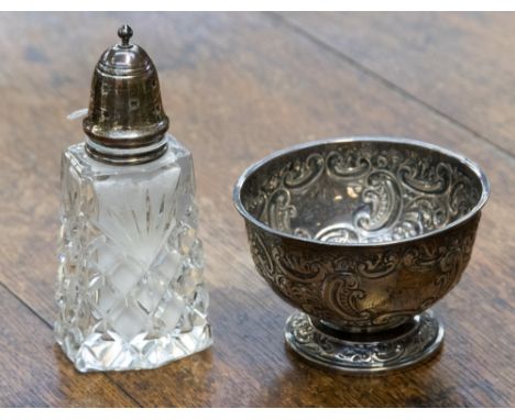 A silver footed embossed bowl, Sheffield 1903 weighting approx 3.43 ozt with a cut glass silver topped sugar shaker, London 1