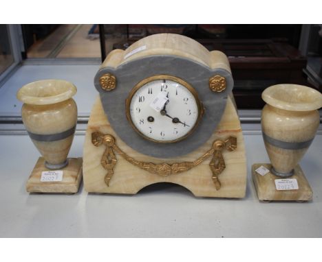 A marble cream and grey mantle clock and garniture Arabic numerals with key