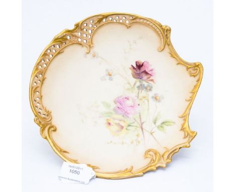 A Royal Worcester blush ivory plate, the edge moulded with Rococo scrolls and fronds, part reticulated, decorated with roses,
