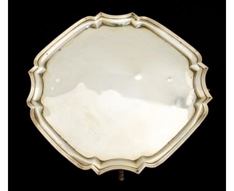 A George V silver salver, octagonal form with ogee  fluted border, on four scroll feet, Martin Hall and Co., Sheffield 1931, 