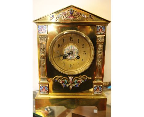 A late 19th Century French brass and champleve enamel bracket clock of architectural form, worn black Arabic numerals, with k
