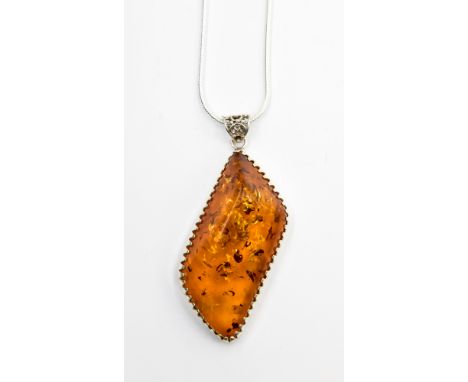 A Baltic Amber pendant necklace, the single piece of amber secured on a white metal mount, fitted on a silver snake link chai