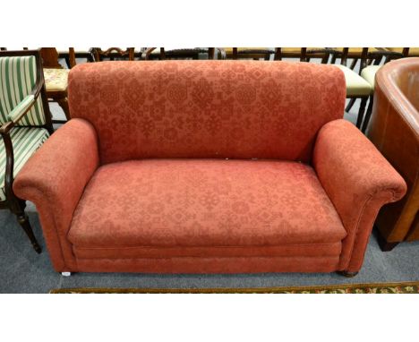 An early 20th century red upholstered drop end sofa 
