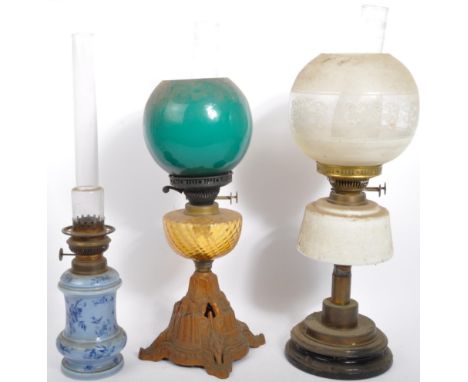 A collection of three 19th century Victorian oil lamps. With an acid etched glass shade with white enamel reservoir on a step