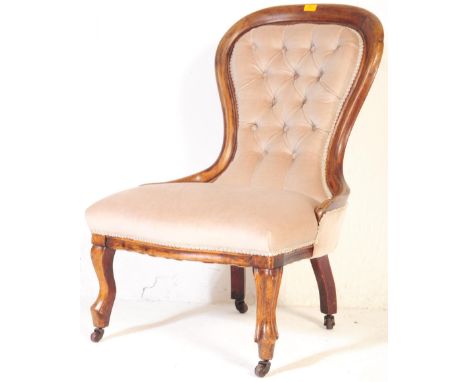 A 19th century Victorian mahogany spoon back ladies nursing chair. The chair having a chesterfield style button back rest wit