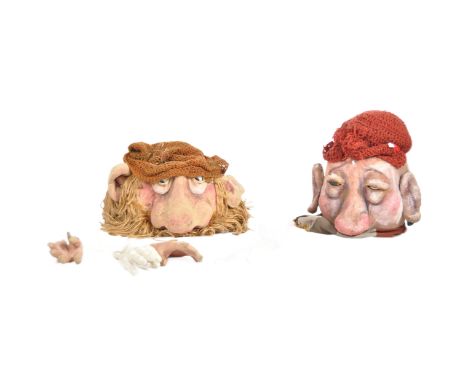 Two large theatre props / stage production heads and arms with woollen accessories and hair. Largest head measures approx. 65