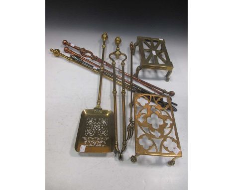 Three matching brass fire irons, two copper fire irons, pair fire dogs, brass trivets (one with lion motif), and other firepl