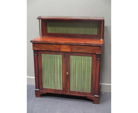 Circa 1820 a mahogany Chiffonier, the raised shelf and brass gallery over two frieze drawers and two door cupboard with key 1