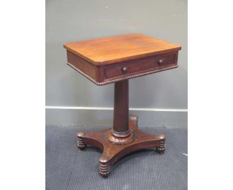 A 19th century mahogany lamp table with single frieze drawer on column support upon a quatraform base with globular bun feet 