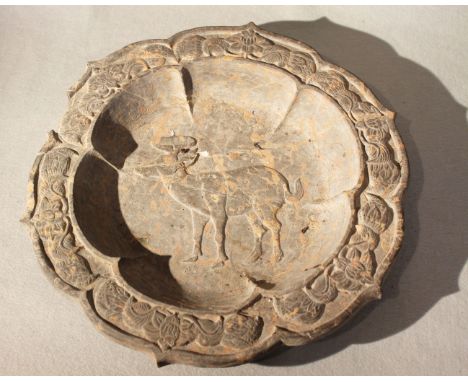 A Chinese limestone shallow basin carved with a deer, in Liao style, bracketed circular, based on a metal prototype (broken),