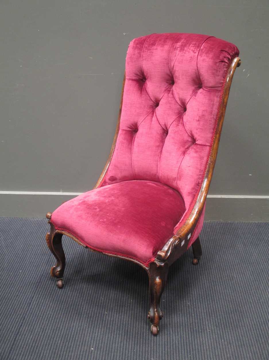 A Victorian mahogany nursing chair, with pink velvet button back