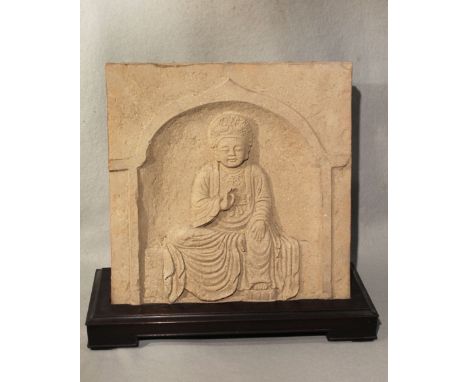 A Chinese red pottery panel in relief with seated Bodhisattva, within an arch, in 6th-7th century style, 36cm high