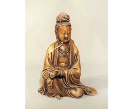 A Chinese carved soapstone figure of Guanyin, seated holding a scroll, Republic Period in Qing style, 22cm high
