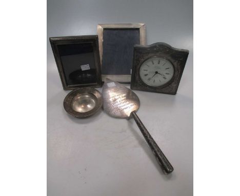 A silver 'Armada' style dish, a silver photograph frame and a silver mounted desk clock, together with a silver plated photog