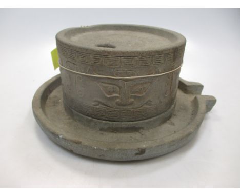 A Chinese stone grinder, in archaic style, 20th century 9cm high 22cm diameter