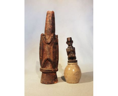 A Yam wood figure Nggwal , Wosera area, Southern Abelam Tribe, 12.5cm high, in an associated ceramic jar, 19cm high overall; 