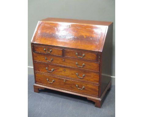 A George III mahogany bureau, circa 1770, with well fitted interior, pigeonholes and drawers above two short and three long d