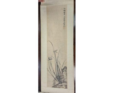 A Chinese Scroll Painting, Late Qing Dynasty/early 20th century, painted with flowering orchids growing from rocks, inscripti
