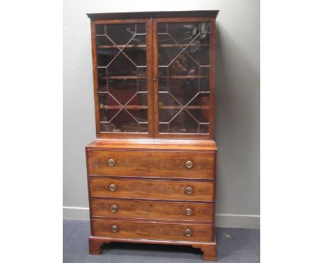 A George III mahogany secretaire bookcase with Greek key moulded cornice above two astragal glazed doors, fitted secretaire d