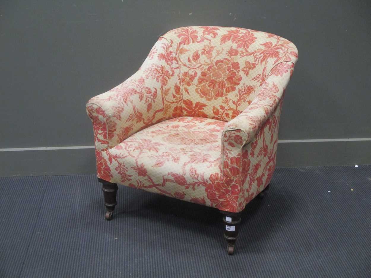 A Victorian tub nursing chair, on mahogany feet with castors in
