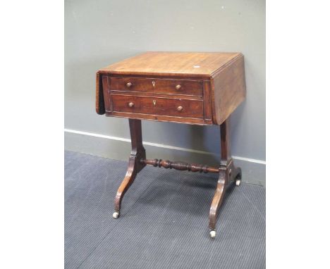 A Regency mahogany work table, the frieze drawer with tooled burgundy leather writing slope, on reeded trestle supports with 