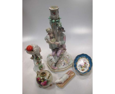 A Meissen style porcelain four-light candelabrum, designed as a father with daughter beneath a rose arbour, on a serpentine s